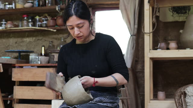 Indigenous Craftmanship: Mapuche Potter Woman Skillfully Shapes Clay Pot, Crafting Rustic Art with Cultural Creativity in Her Skilled Hands