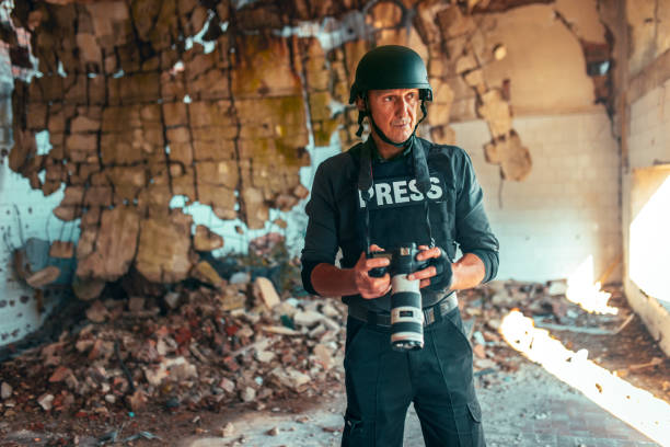 istock man war journalist with camera on the field 1804183557