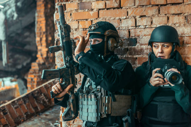 istock journalists and a soldier are hiding from the bullets 1804195413