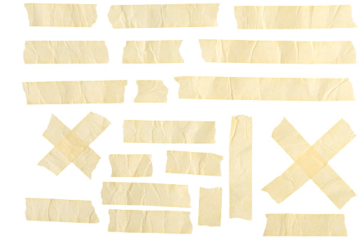 This photo features an array of masking tape and adhesive strips arranged on a plain white background. Various lengths of beige colored duct tape are shown.