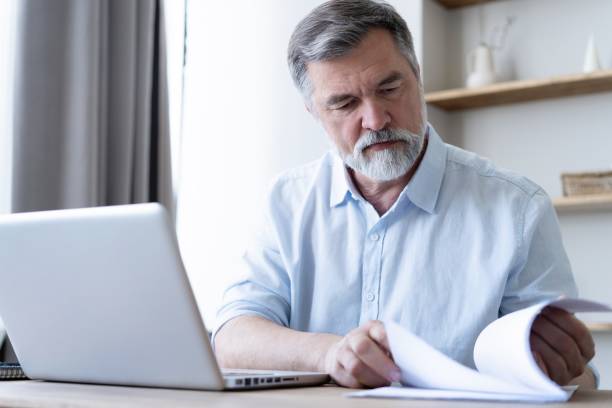 istock Man working on laptop from home. Counting financial data. 1804217954