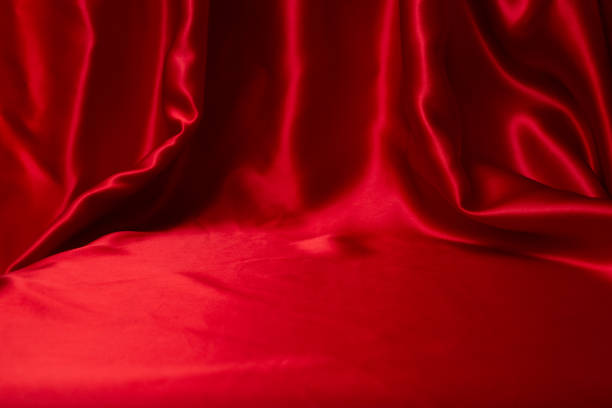 istock staged red satin with folds and empty space for text or product placement 1804219020