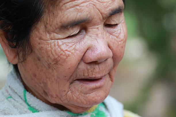 istock old woman closes one's eyes 180423073
