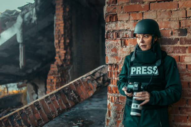 istock a female photojournalist in a war zone 1804231539