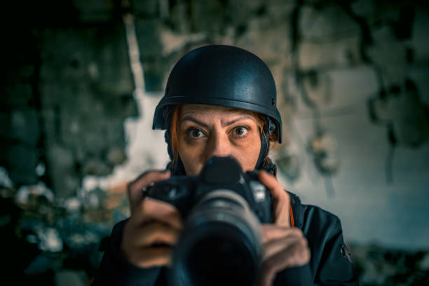 istock a female photojournalist in a war zone 1804232059
