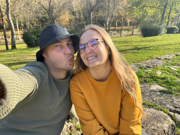 istock Man taking selfie with his girlfriend outdoors. 1804237523