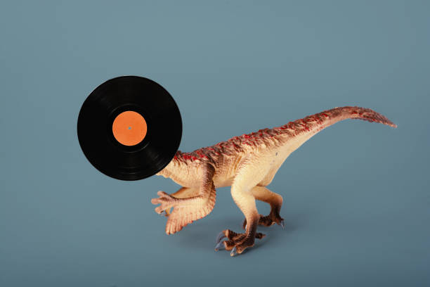 istock Dinosaur toy with vinyl record over head 1804242424
