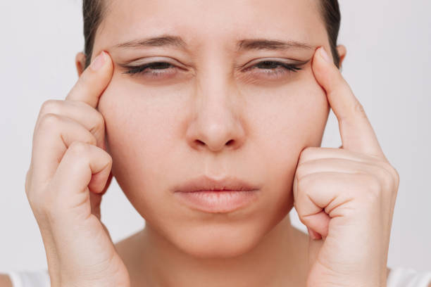 istock Young caucasian woman with poor eyesight squints pulling eyelids to the sides with hands 1804244003