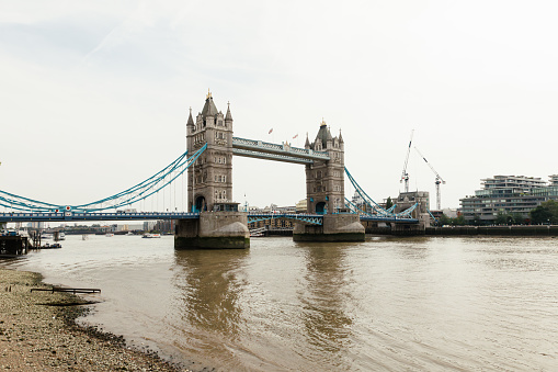 General view of the London Bridge also called Tower bridge over the Thames river in London on an overcast day