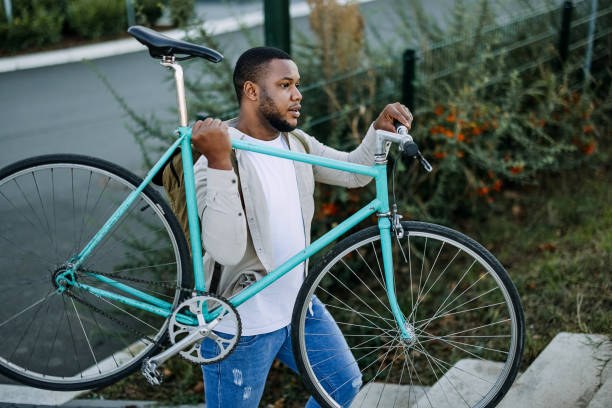 istock Man carries a bicycle up the stairs 1804258495