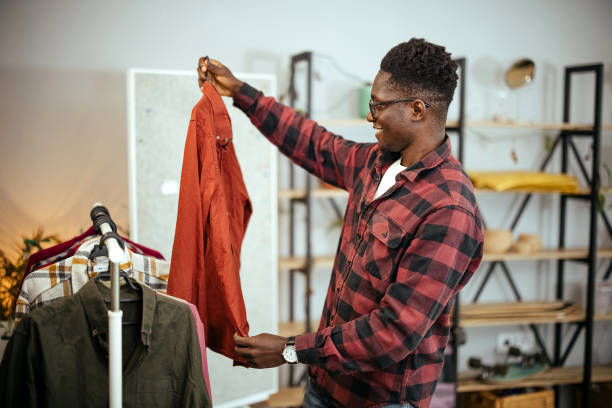 istock Man is choosing shirts to sell 1804261755