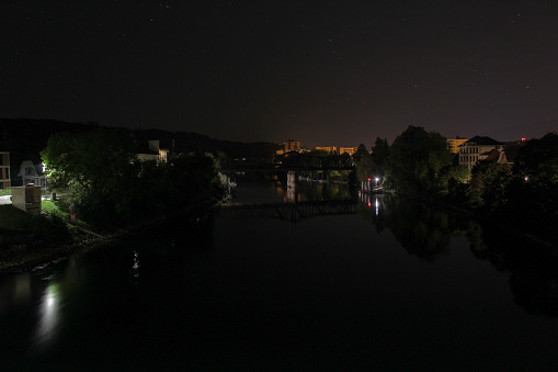 nocturnal landscape with river flowing through a suburban area