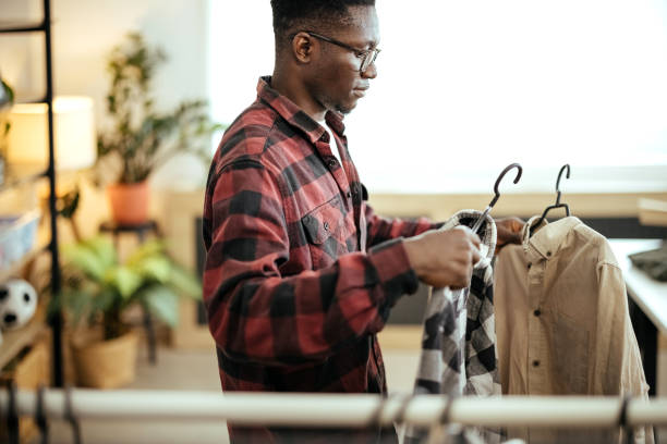 istock Man is choosing shirts to sell 1804267489