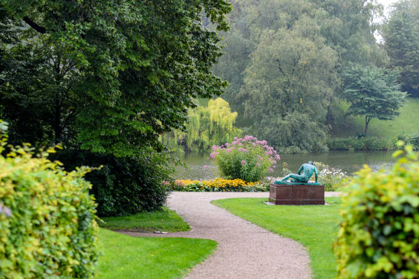 View of Orsted Park (Ørstedsparken) public park during summer in Copenhagen, Denmark. The statue is a replica given by the Albertina Foundation. The 'original' is an Ancient Roman marble copy of a lost Hellenistic sculpture.