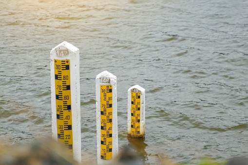 There are 3 sizes of cement poles to measure the water level in the reservoir to measure large amounts of water in the rainy season. and less water in the dry season. Soft and selective focus.