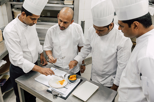 Professional chefs in a commercial kitchen of a fine dining restaurant
