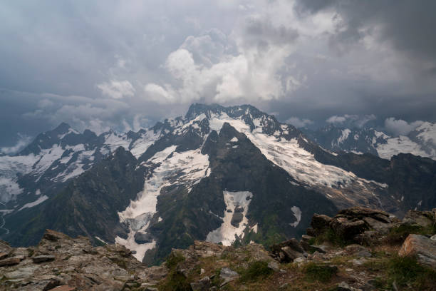 View of the Dzhuguturluchat mountain range of the Great Caucasus Range from the upper station of the cable car of the Dombay ski resort on a summer day, Karachay-Cherkessia, Russia