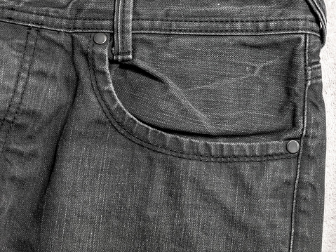 Close-up jeans detail photo in studio. No people.