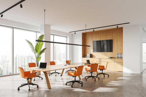 Cozy conference interior with chairs and board, side view tv screen with sideboard. Stylish meeting or work corner with panoramic window on Kuala Lumpur. 3D rendering