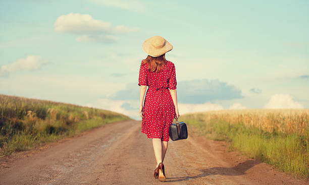 istock Redhead girl with suitcase at outdoor. 180432332