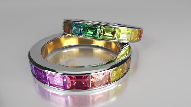 Two rings with multi-colored precious stones