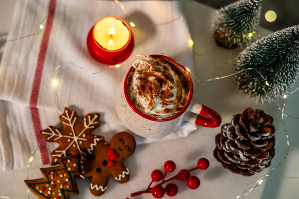 istock gingerbread cookies cone candle and sweet drinking with cream are on white table horizontal christmas still 1804327766
