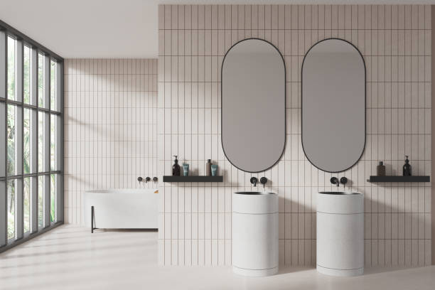 istock White tile bathroom interior with double sink and tub 1804328846