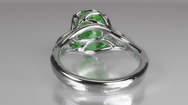 Ring with green gemstone and floral design