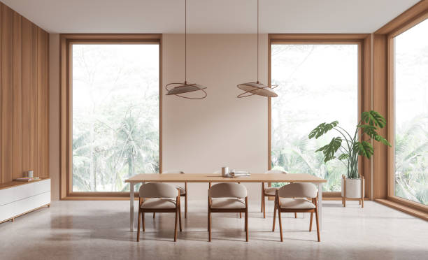 istock Wooden living room interior with table and chairs, drawer and panoramic window 1804337421