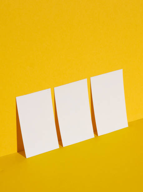 istock White business cards on yellow background with shadow. Creative layout 1804339573