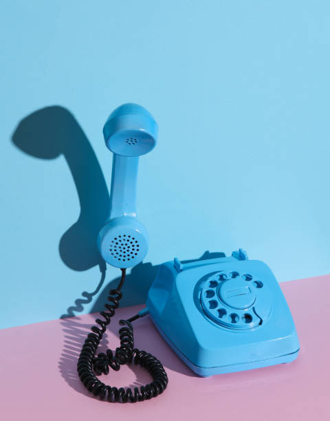 istock Blue Rotary retro rotary telephone with floating handset on pink blue background with shadow. Creative layout 1804340129