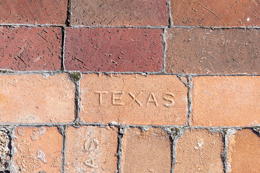 vintage brick floor in Texas build with red bricks with inscription Texas