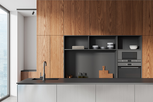 Stylish home kitchen interior with bar island and cabinet with kitchenware