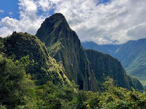 An awe-inspiring landscape of Huayna Picchu mountain in Peru featuring a lush green valley in the foreground