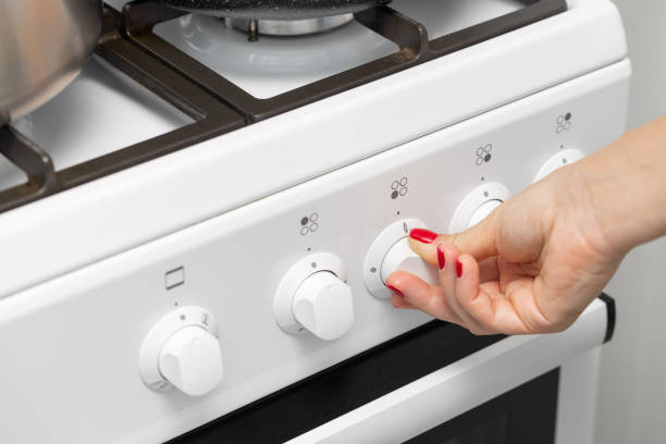 istock a woman's hand rotates the selector on a gas stove. 1804365206