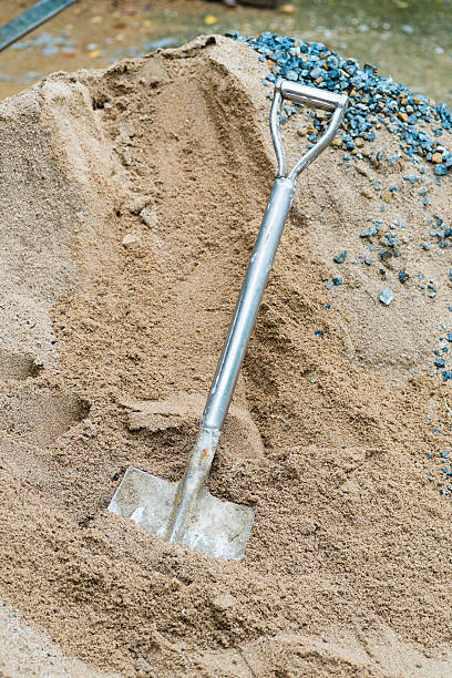 istock shovel and sand in construction place 180437757