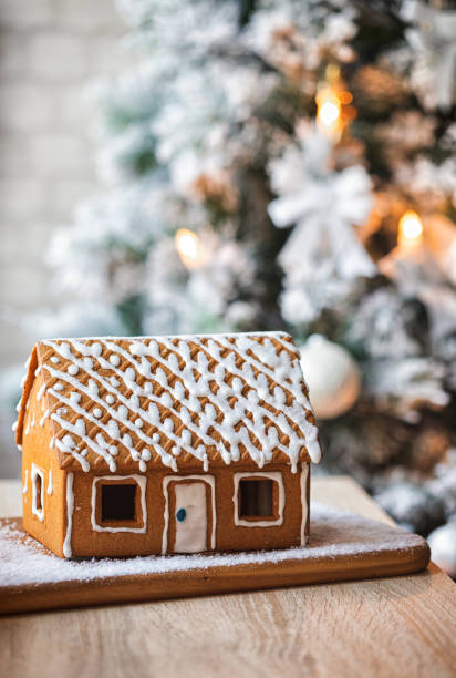 istock Homemade gingerbread house in front of Christmas tree 1804382766