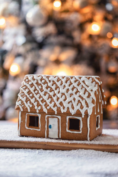 istock Homemade gingerbread house in front of Christmas tree 1804382773