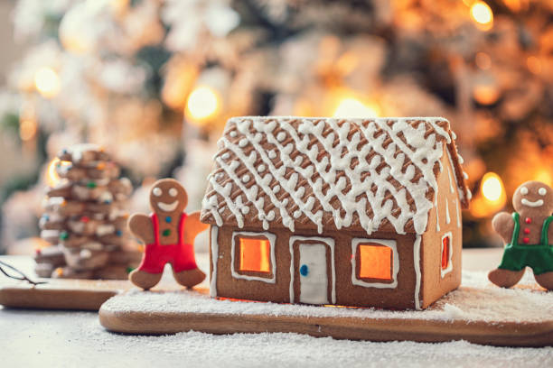 istock Homemade gingerbread house in front of Christmas tree 1804383285