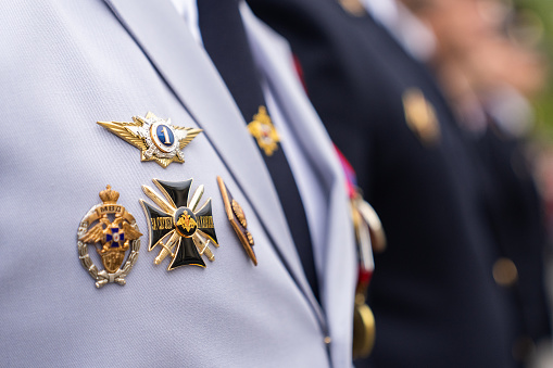 Arlington County, United States – April 21, 2019: A soldier standing at attention and holding a rifle while in a uniform outside of a building