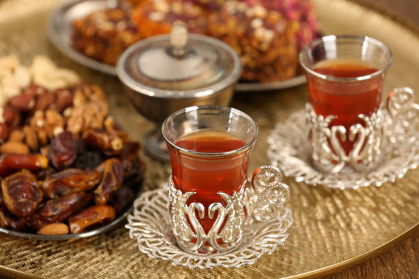 istock Glasses with tasty Turkish tea and sweets on wooden table 1804389732