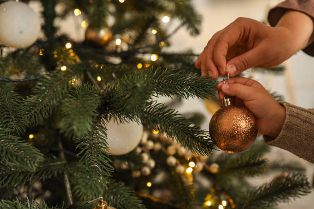 istock Mom and child decorate the Christmas tree 1804401231