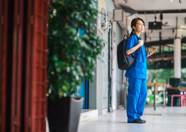 istock Focused and Composed: Chinese Nurse After Shift with Laptop Bag 1804402317
