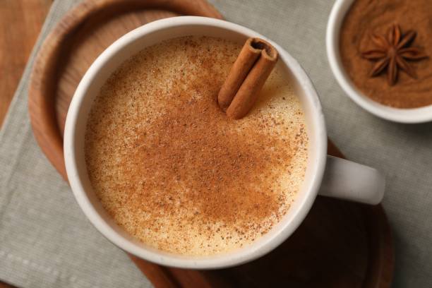 istock Delicious eggnog with anise and cinnamon on wooden table, top view 1804407767