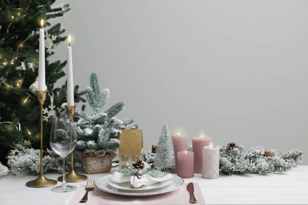 istock Festive place setting with beautiful dishware, cutlery and cone for Christmas dinner on white wooden table. Space for text 1804408294