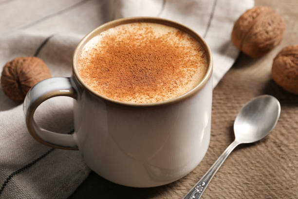 istock Delicious eggnog with cinnamon on wooden table, closeup 1804409396