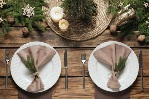 istock Festive place setting with beautiful dishware, cutlery and fabric napkin for Christmas dinner on wooden table, flat lay 1804409918