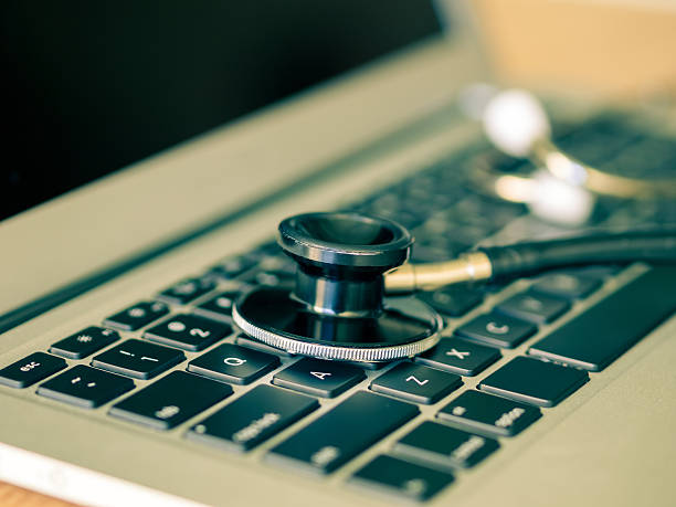 Close up of stethoscope on a laptop stock photo