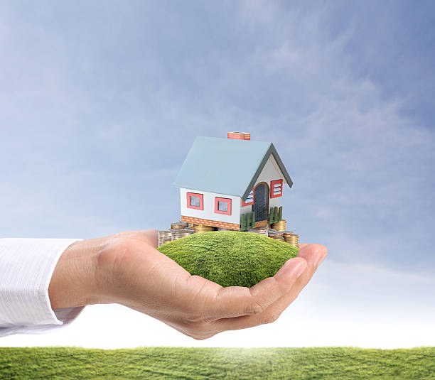 istock holding house representing home ownership 180441239