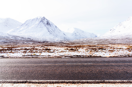 A roadside view during winter of the A82 trunk road through Glencoe.